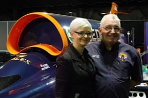 Photo of Jess Herbert and Nick Naylor with a model of the Bloodhound car at the GUTS event, MAGNA